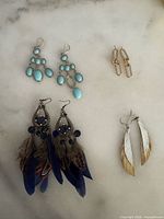 All four pairs of earrings arranged on surface
