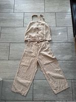 Full view of matching top and pants laid flat