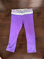 Front view of purple cropped Lululemon pants showing floral waistband