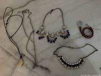 Overall view of five jewellery pieces