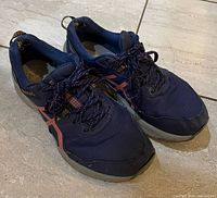 Top view of pair of navy Asics running shoes showing overall design and condition