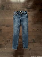 Front view of jeans showing full length and wash