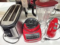 Toaster, blender base with jar and lid, hand mixer cords visible