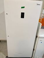 Front view of upright freezer showing exterior door and control panel