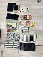 All items laid out showing 12 cloth towels and 7 napkin packs