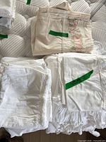 Stack showing cream floral and white sheets grouped together