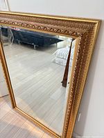 Front view showing full mirror and ornate frame