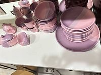 Full set on countertop showing plates, bowls, cups, serve pieces