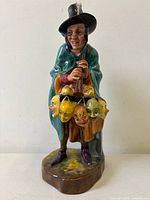 Front view of Royal Doulton The Masque Seller figurine