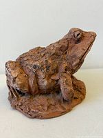 Front side of terra cotta frog sculpture