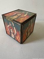 Closed cube showing printed Anima Sola image and metal edges