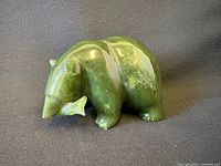 front view of jade bear holding salmon