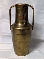 Front view showing brass vase, handles, crest