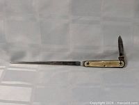 Side view of antique combination letter opener and folding knife fully open