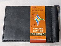 Front view of black leather billfold with original tag attached