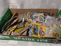 Overview of box filled with assorted loose trading cards