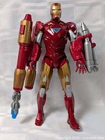 Full view of Iron Man figure standing with weapons attached