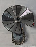 Flash unfolded showing full circular reflector and coiled cord