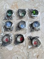 All nine stainless steel lockets in sealed bags with chains