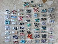 Full lot of assorted cabochon bags with coin for scale