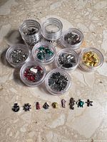 All ten containers and sample charms arranged on surface