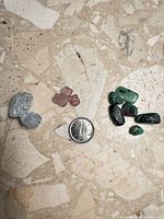 Group shot of all stones with coin for scale