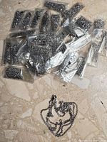 All 36 necklaces, most factory-sealed in individual plastic sleeves