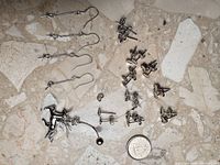 Full lot showing all sterling silver earring findings with quarter for scale
