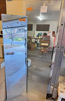 Both frameless mirrors standing upright