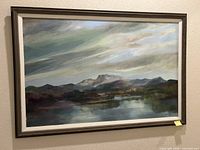 Full view of framed landscape painting on wall