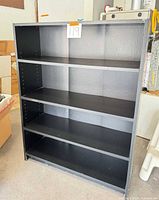 Front view of entire black bookcase with shelves