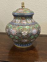 Front view of cloisonné vase with lid and finial