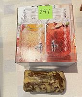 Box showing pair of glass beverage dispensers and ceramic loaf box