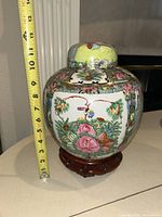 Ginger jar on stand with lid, tape measure showing height