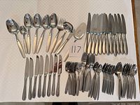 Full arrangement of Oneida flatware, serving pieces and Henckels steak knives