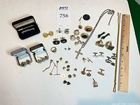 Overview of entire lot displaying cufflinks, tie bars, tacks, chains, studs, pendants, rings