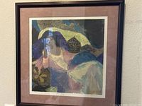 Framed abstract lithograph behind glass