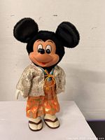 Front view of Mickey Mouse doll in hakama showing full costume and sandals