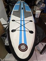 Top view of paddle board showing deck pad, stripes, bungee tie-downs