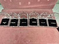 All six costume rings each in individual display cases