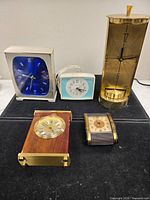 Group shot of all five vintage clocks