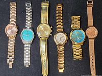 Front view of all six wristwatches showing dial designs, metal tones and straps