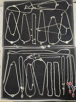 overview of two trays containing all silver-tone jewellery pieces