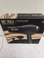 Front of retail box displaying image of hair dryer with concentrator and diffuser