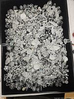 Overview of entire lot in tray, showing large quantity of clear beads and rhinestones