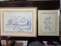 Both framed pictures side by side on table