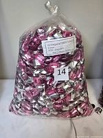 Sealed plastic bag filled with pink and silver-backed octagon rhinestones, label indicating Octagons7207/18x13 rose 200 dozen Made in Western Germany