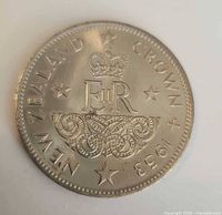 Reverse of 1953 New Zealand Crown showing EIIR cypher, crown, Maori carving, date and legend