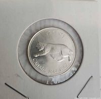 Obverse showing bobcat reverse of 1967 silver quarter in holder