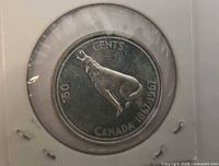 Reverse of 1967 50 cents coin showing howling wolf and 1867-1967 dates